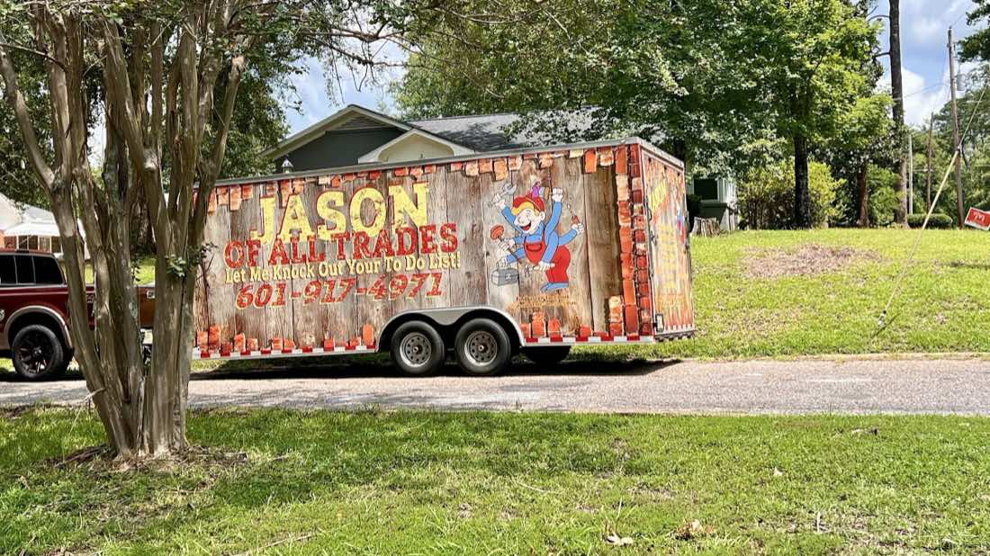 Jason of all Trades branded work trailer parked on a Meridian street